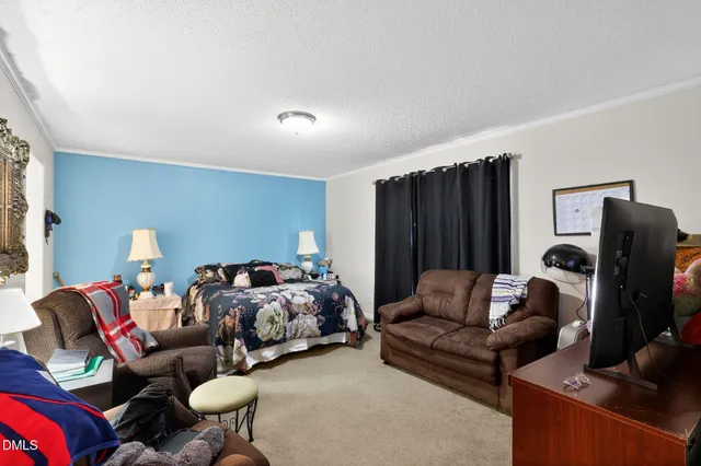 a living room with furniture ceiling fan and a window