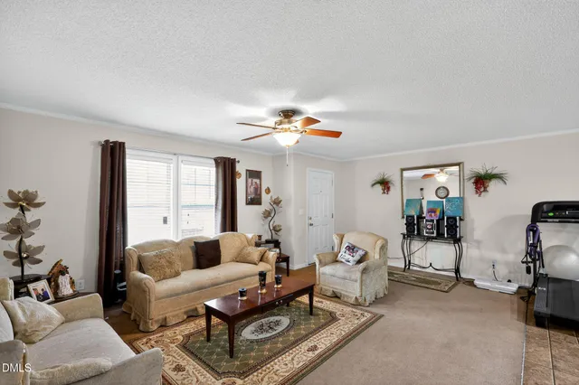 a living room with furniture a chandelier and a window