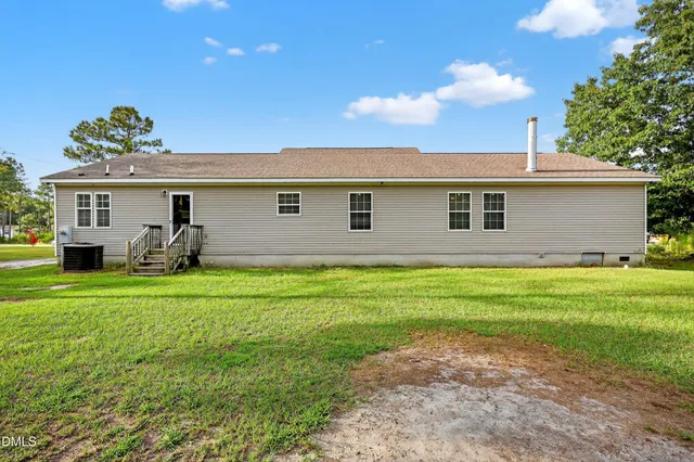 a front view of house with a garden