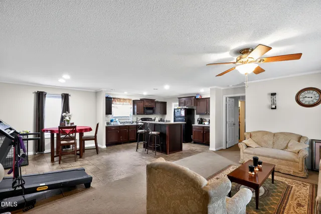 a living room with furniture and kitchen view
