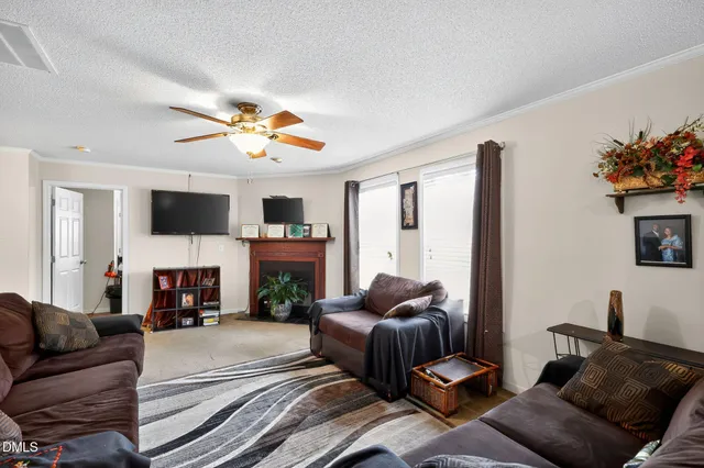 a living room with furniture a fireplace and a flat screen tv