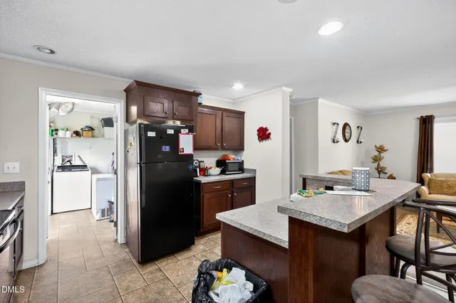 a kitchen with a refrigerator a stove and a sink