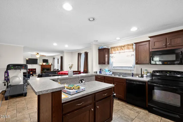 a kitchen with a sink stove top oven and microwave