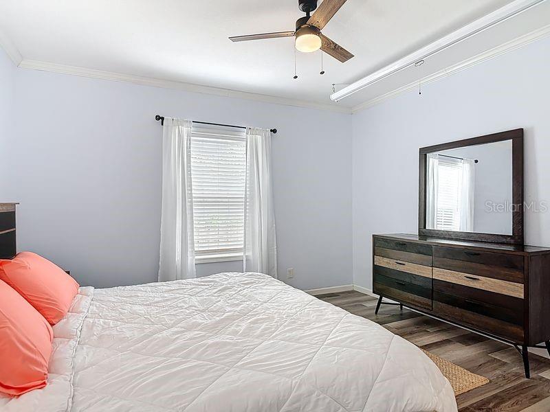 102 Ash Street Edgewater, FL 32141 - Photo 17 of 36 a bedroom with a bed and a chandelier