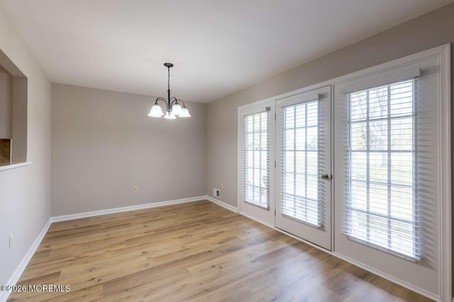 43 Poplar Place Freehold, NJ 07728 - Photo 11 of 31 wooden floor in an empty room with a window