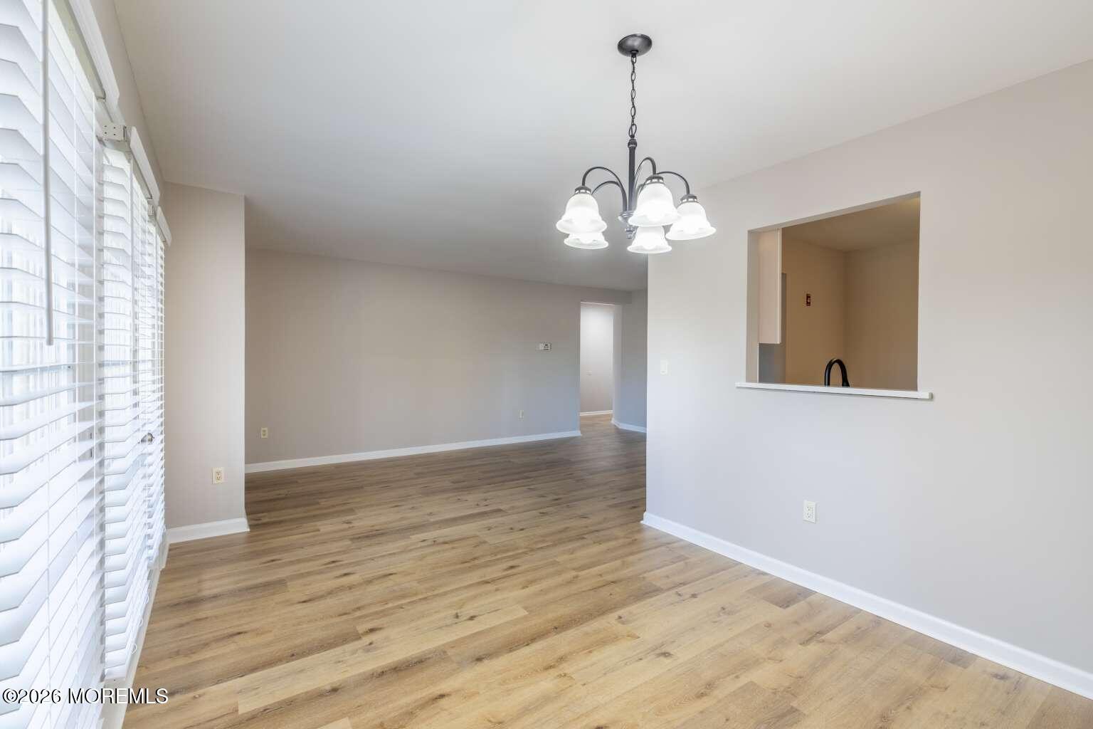 43 Poplar Place Freehold, NJ 07728 - Photo 12 of 31 a view of a room with a chandelier and wooden floor