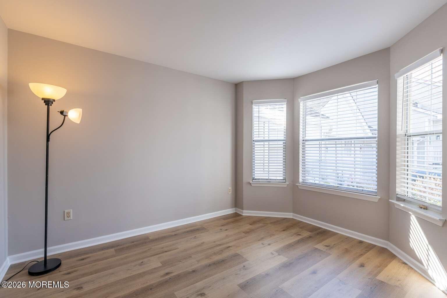 43 Poplar Place Freehold, NJ 07728 - Photo 13 of 31 a view of an empty room with wooden floor and a window
