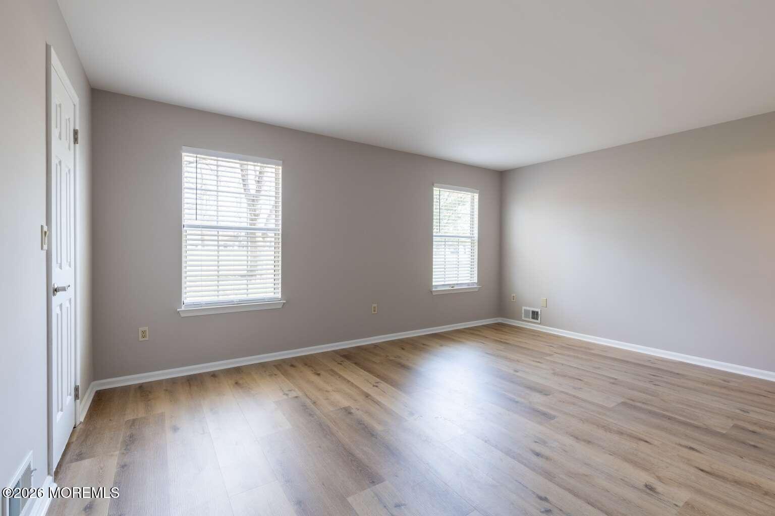 43 Poplar Place Freehold, NJ 07728 - Photo 17 of 31 an empty room with wooden floor and windows