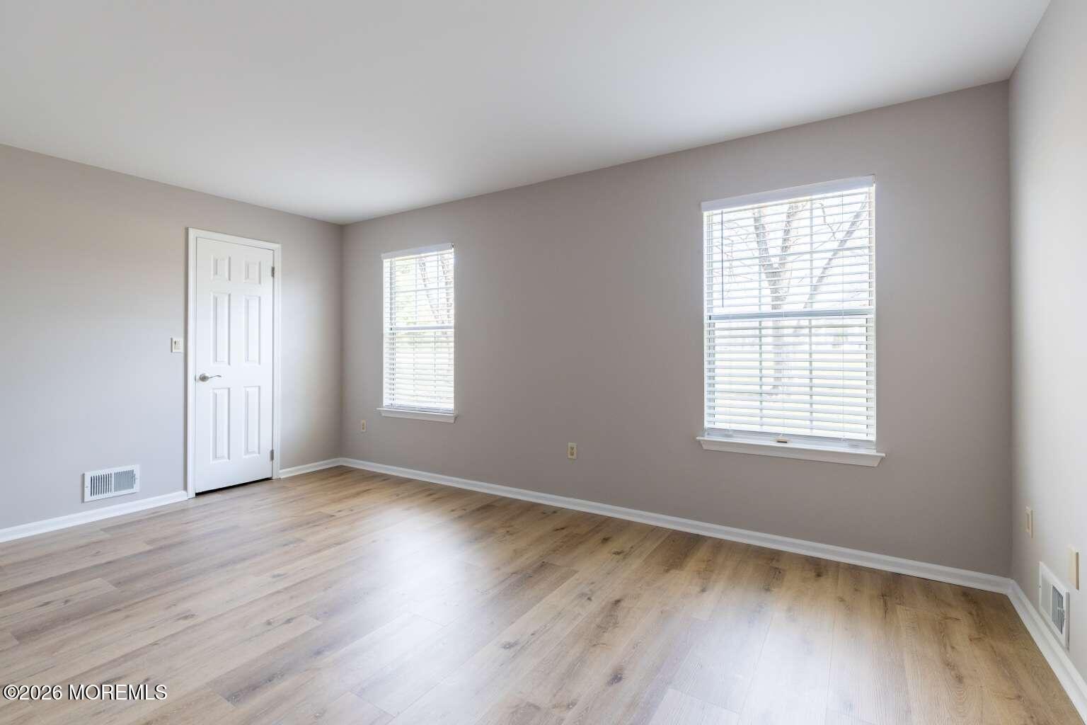 43 Poplar Place Freehold, NJ 07728 - Photo 19 of 31 a view of an empty room with wooden floor and a window