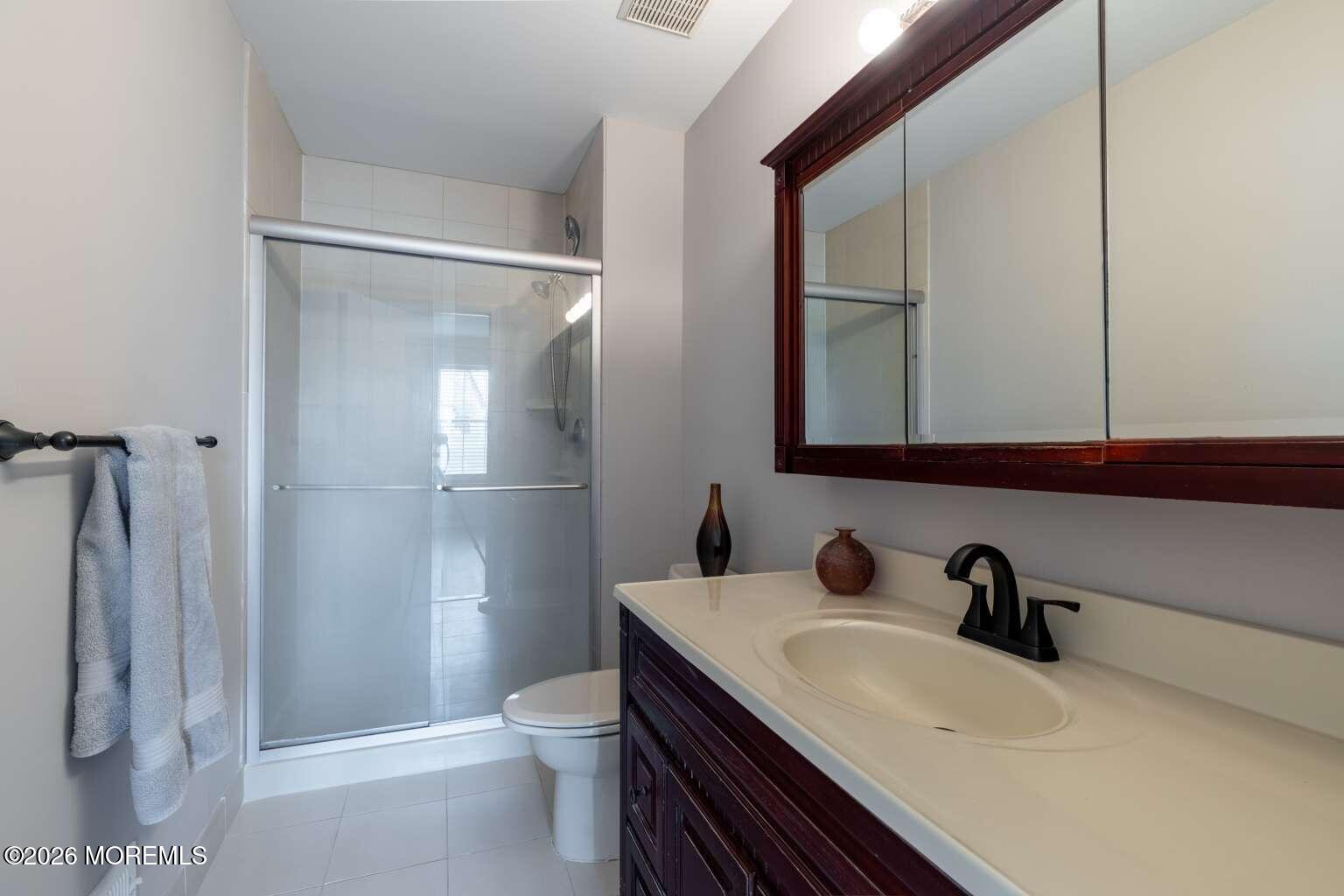 43 Poplar Place Freehold, NJ 07728 - Photo 22 of 31 a bathroom with a sink a toilet and shower