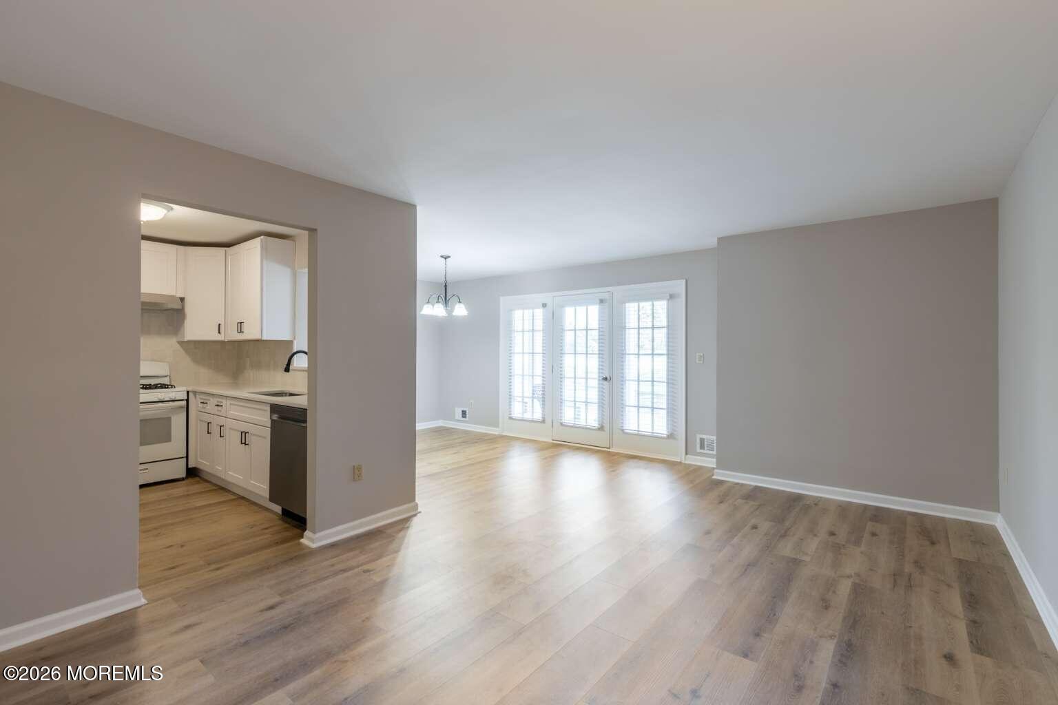 43 Poplar Place Freehold, NJ 07728 - Photo 3 of 31 a view of an empty room with a window and wooden floor