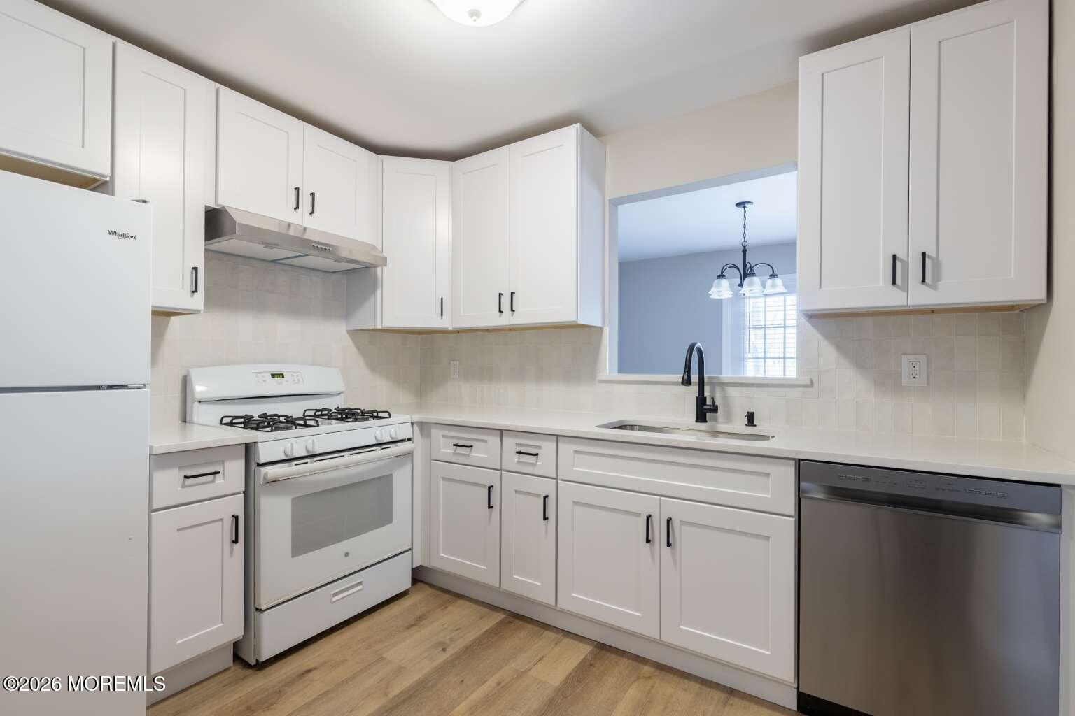 43 Poplar Place Freehold, NJ 07728 - Photo 6 of 31 a kitchen with white cabinets and white appliances
