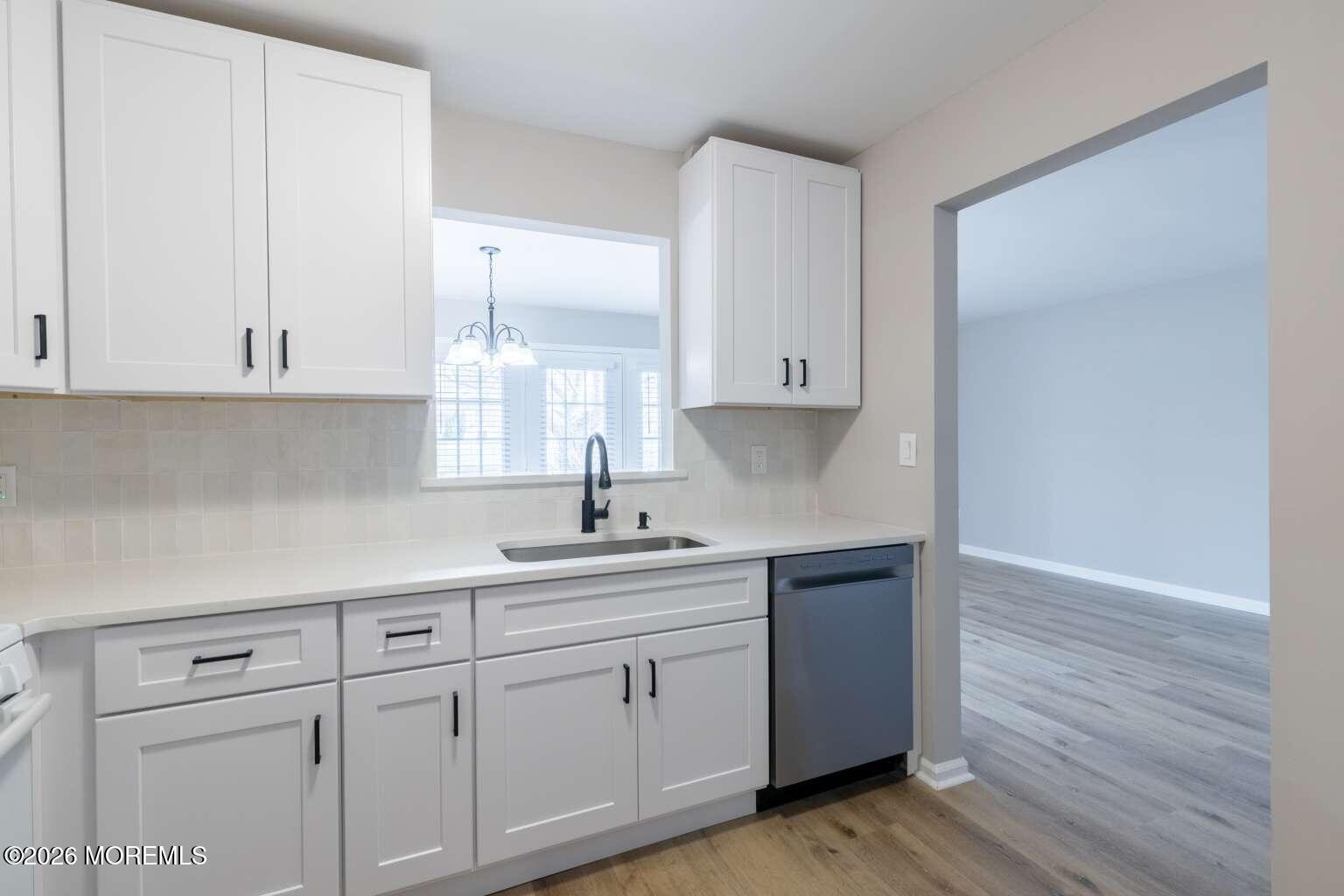 43 Poplar Place Freehold, NJ 07728 - Photo 7 of 31 a kitchen with white cabinets white appliances and sink
