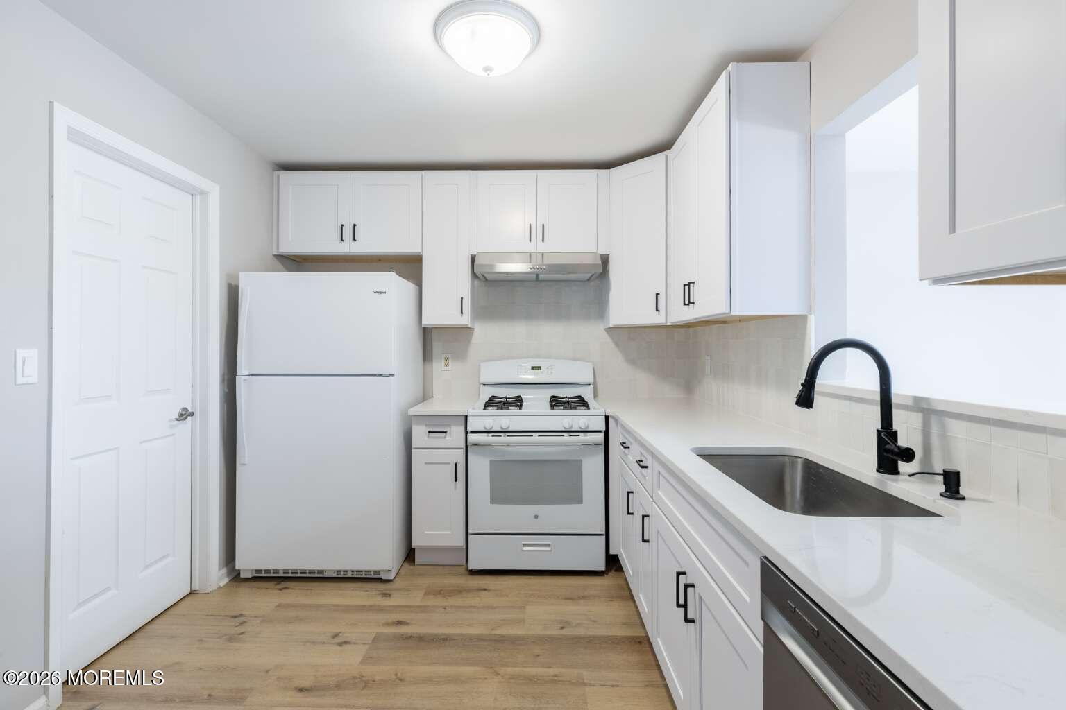 43 Poplar Place Freehold, NJ 07728 - Photo 9 of 31 a kitchen with a sink cabinets and stainless steel appliances