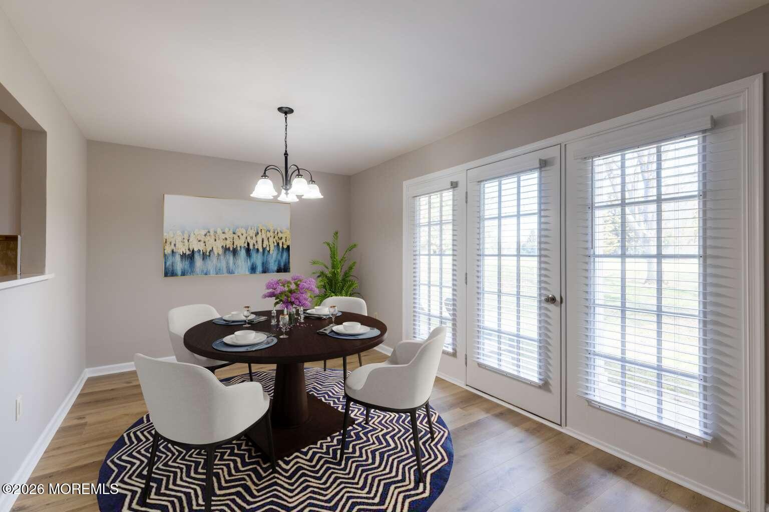43 Poplar Place Freehold, NJ 07728 - Photo 10 of 31 a living room with furniture a chandelier and a window