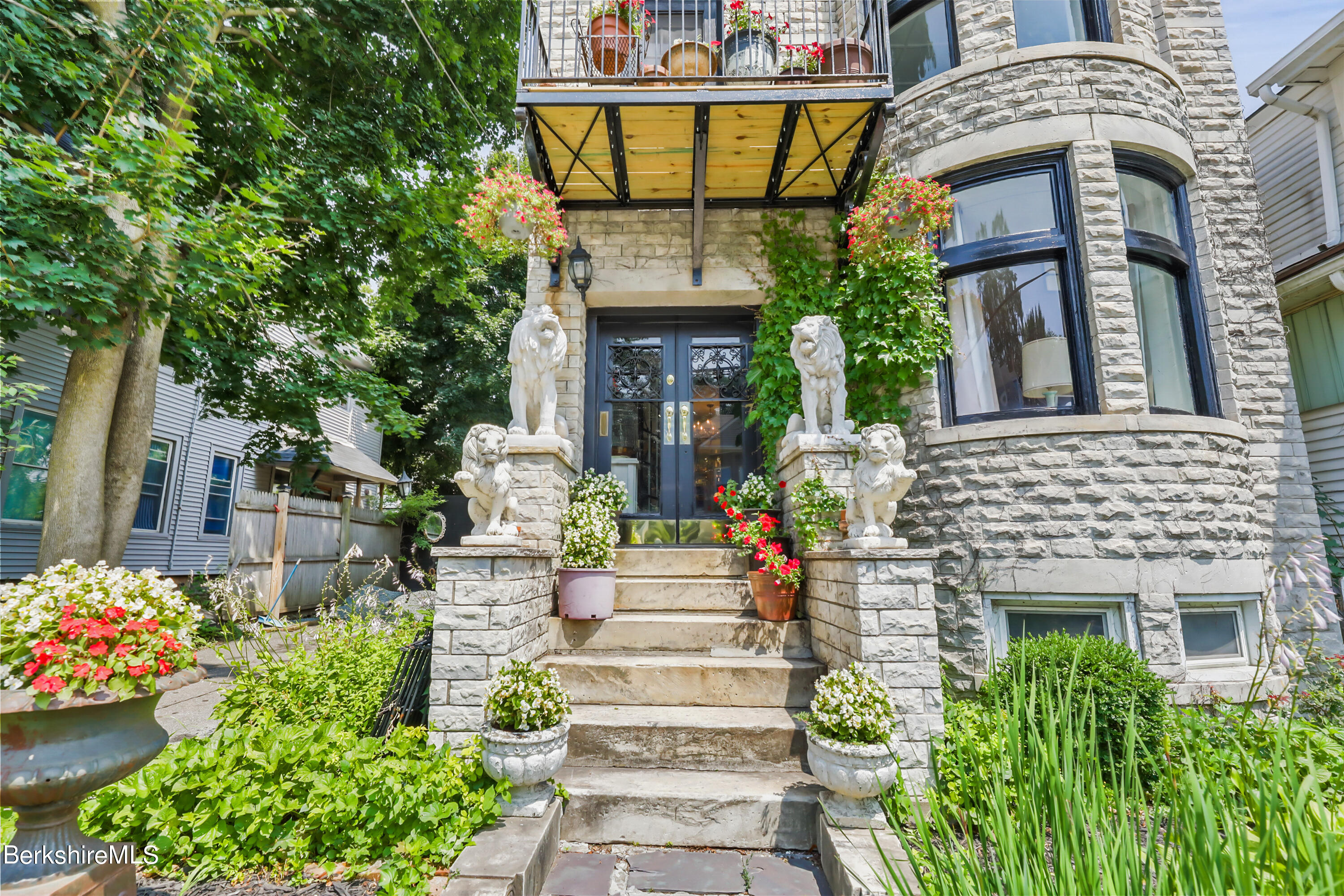 7 Lincoln Street Pittsfield, MA 01201 - Photo 2 of 25 a front view of a house with a garden
