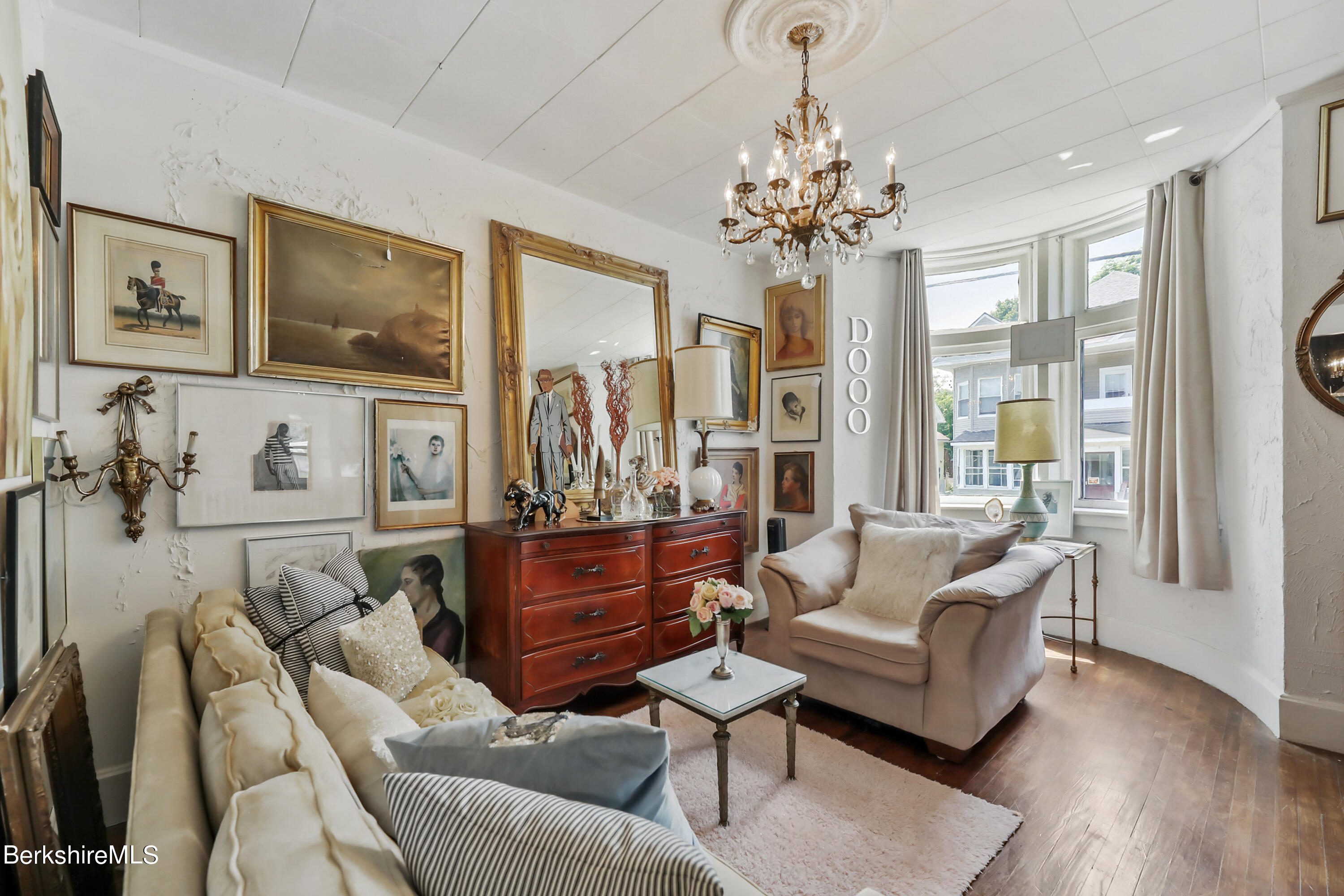 7 Lincoln Street Pittsfield, MA 01201 - Photo 5 of 25 a living room with furniture a chandelier and a flat screen tv