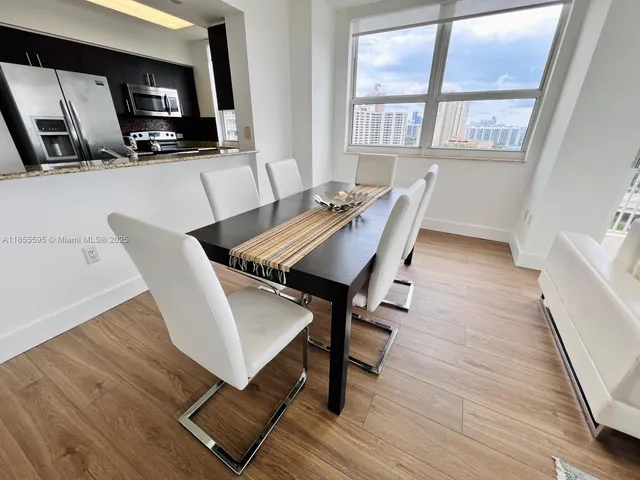 a view of a dining room with furniture window and wooden floor