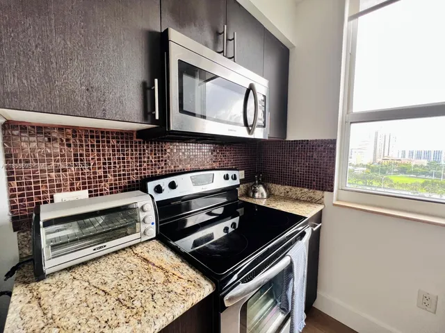 a stove top oven sitting inside of a kitchen