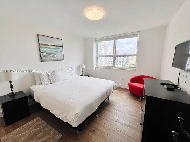 a bedroom with bed and window