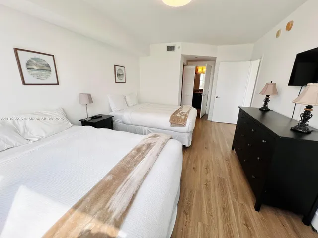 a bed room with two bed and a couch