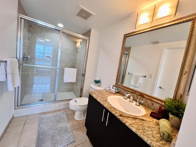 a bathroom with a sink and mirror with toilet