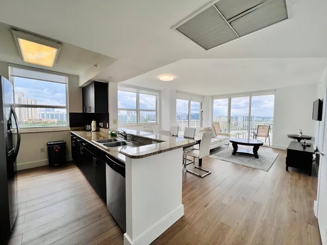 a kitchen with a stove and wooden floor