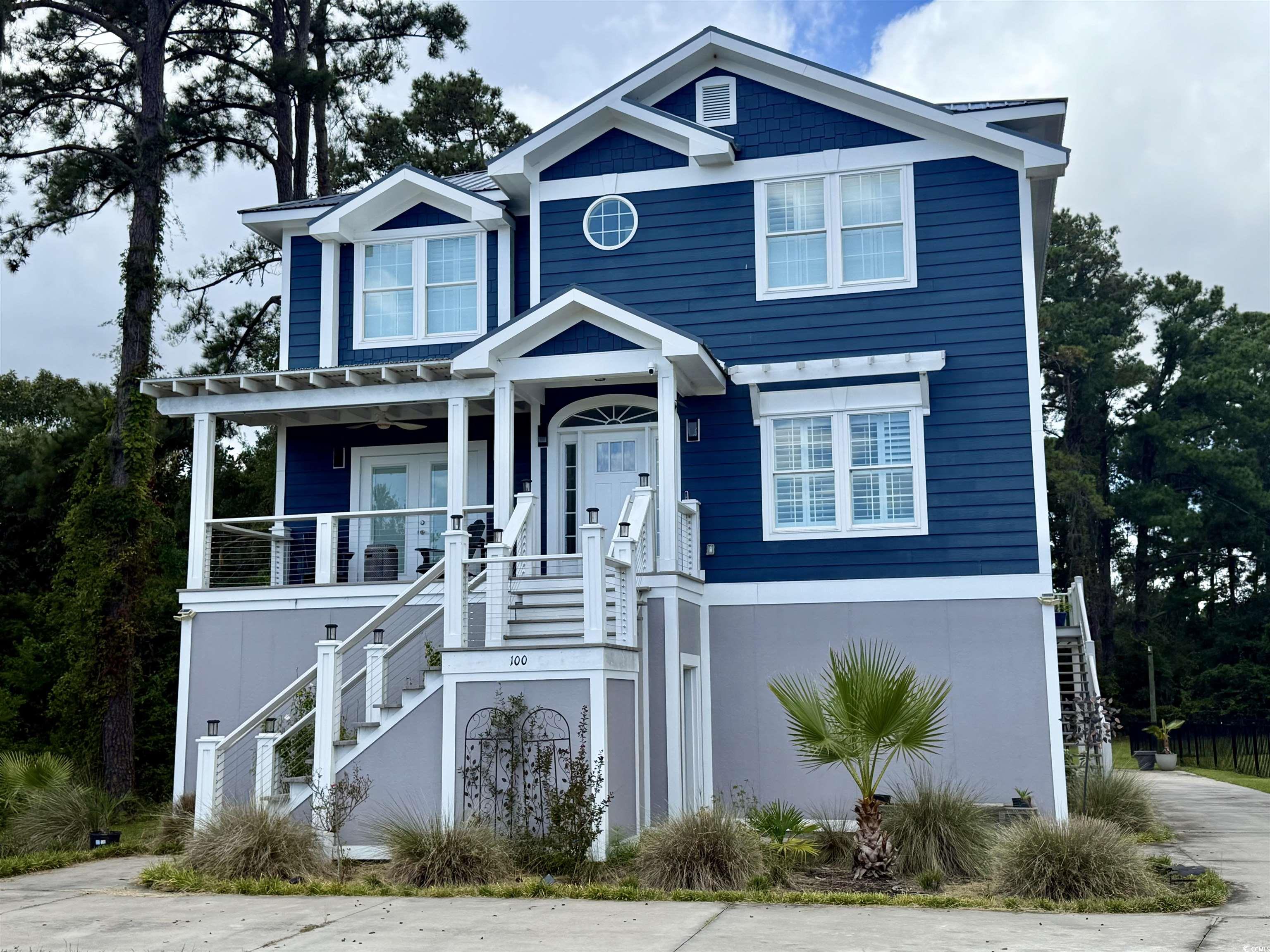 100 Oak Bay Drive Georgetown, SC 29440 - Photo 2 of 29 Beach home with stairway, covered porch, and stucco siding