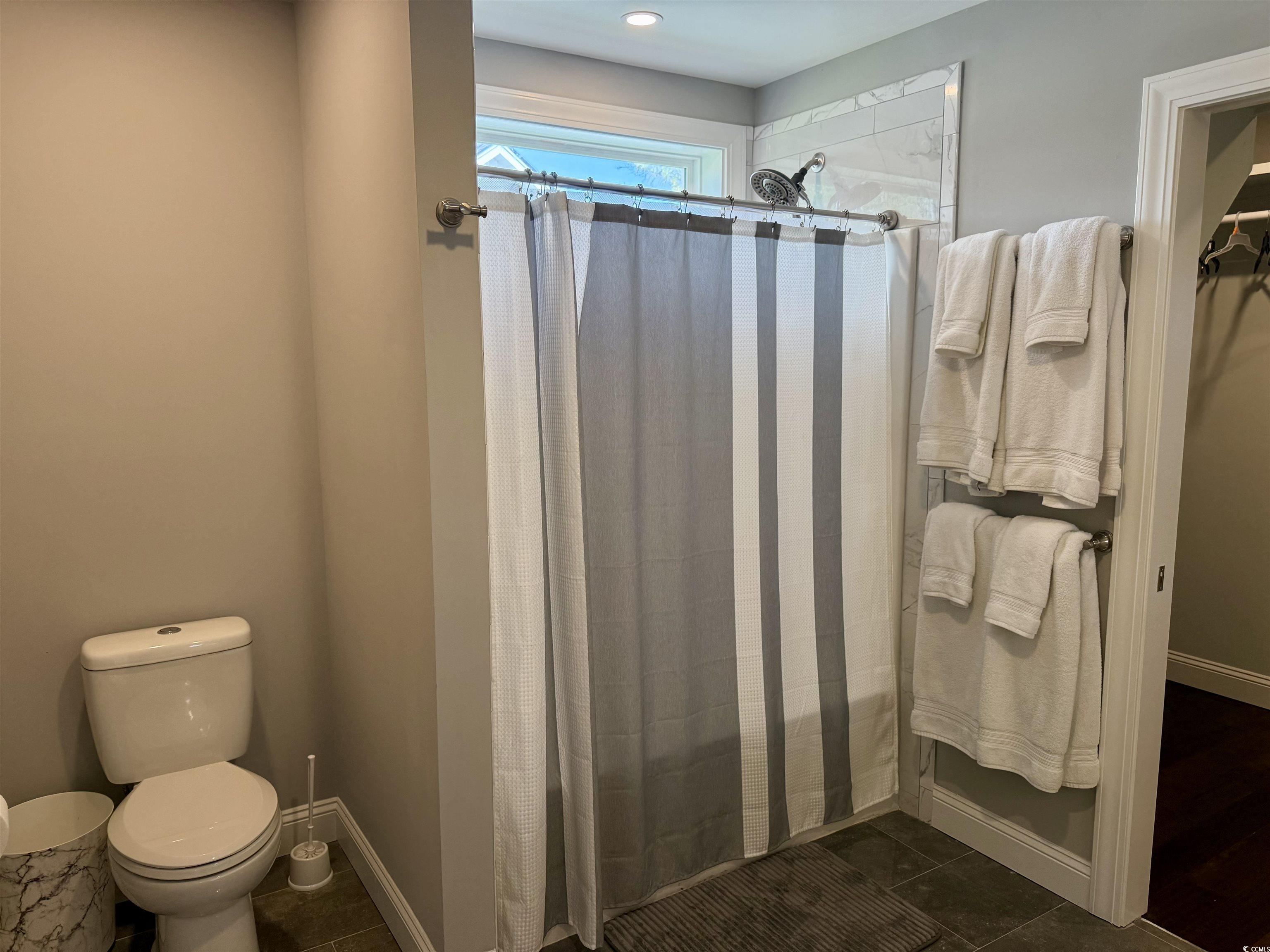 100 Oak Bay Drive Georgetown, SC 29440 - Photo 23 of 33 Full bath with dark tile patterned floors and a stall shower