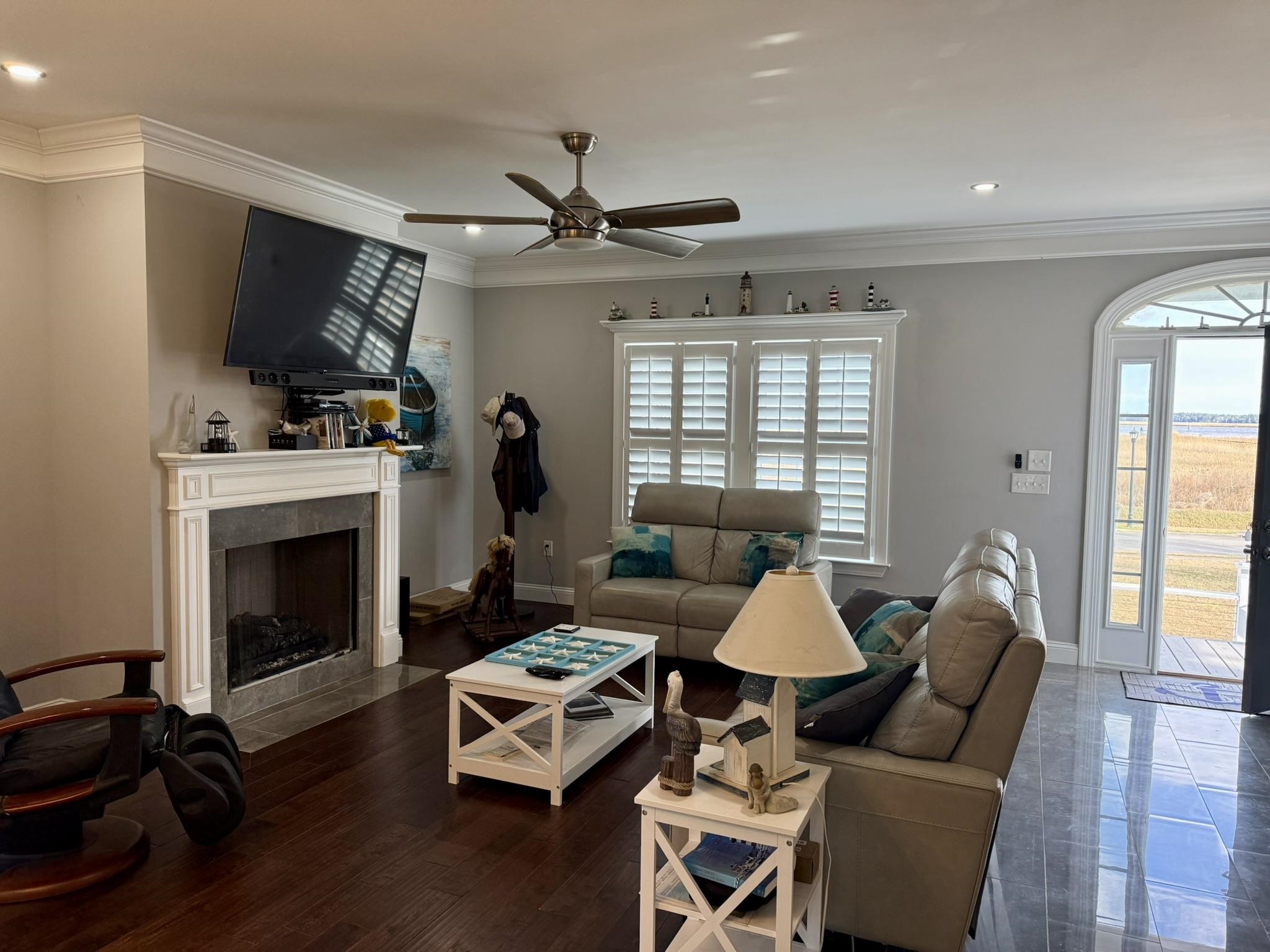 100 Oak Bay Drive Georgetown, SC 29440 - Photo 6 of 33 Living area featuring a tile fireplace, crown molding, recessed lighting, and a ceiling fan