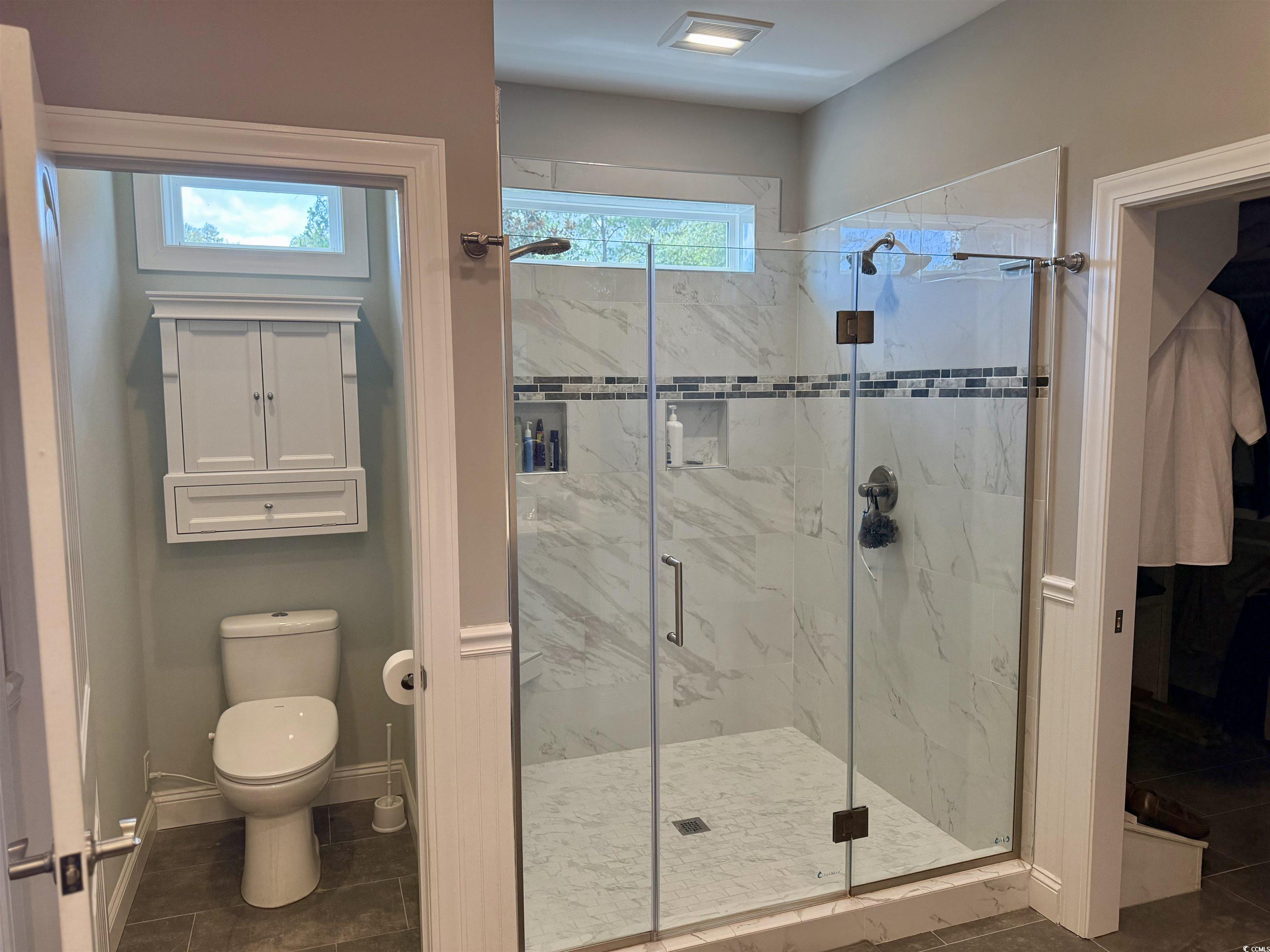 100 Oak Bay Drive Georgetown, SC 29440 - Photo 9 of 33 Full bathroom featuring a marble finish shower and dark tile patterned flooring