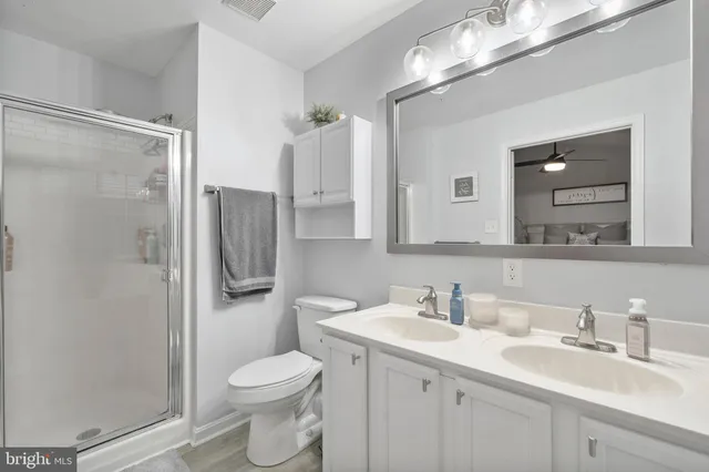 a bathroom with a toilet sink shower and mirror