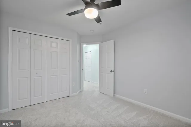 an empty room with chandelier fan