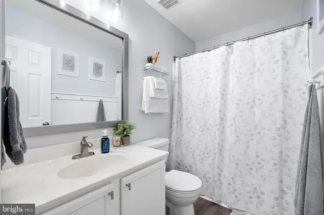 a bathroom with a sink toilet and a mirror