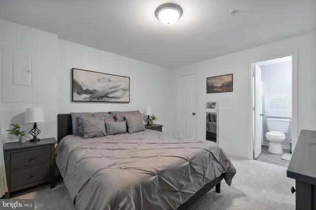 a bedroom with a bed and a view of bathroom