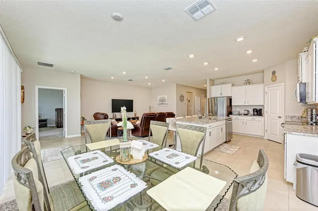 a view of a dining room with furniture and a window