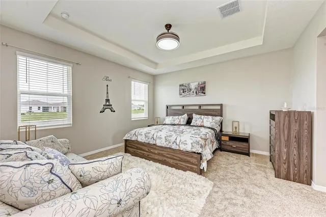 a bedroom with a large bed and a couch