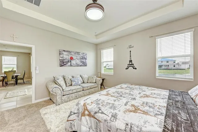 a bedroom with a large bed and a chandelier