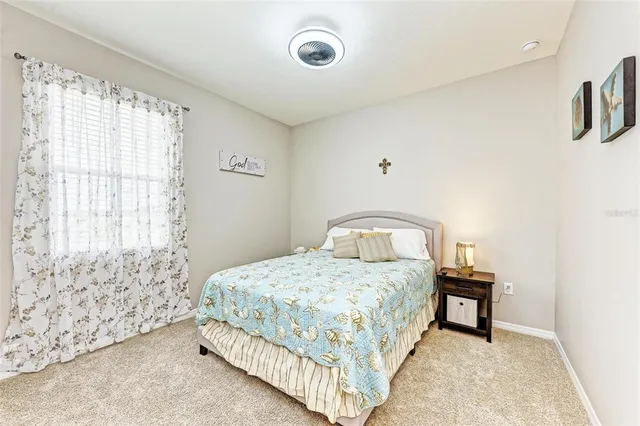 a bedroom with a bed and a wall painting