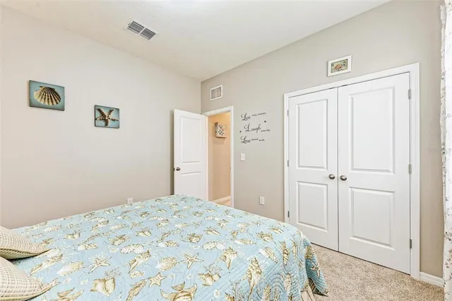 a view of washer and dryer with bathroom in the background