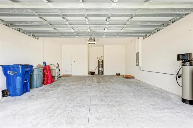 a living room with stainless steel appliances kitchen island granite countertop a sink and cabinets