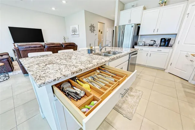 a kitchen with white cabinets and a sink