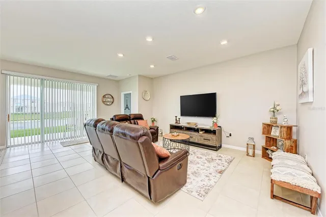 a living room with furniture and kitchen view