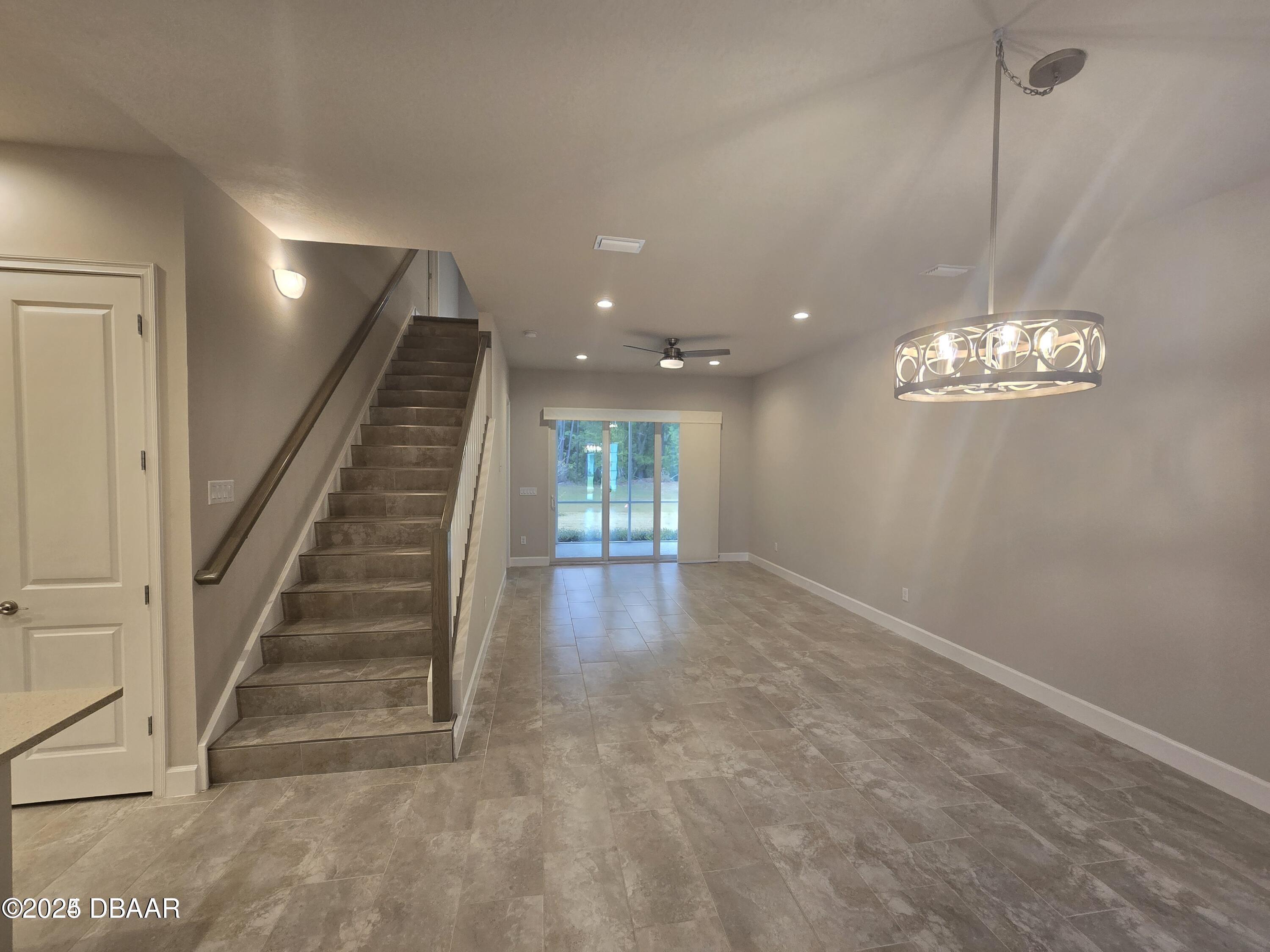 54 Longridge Lane Ormond Beach, FL 32174 - Photo 4 of 16 a view of livingroom with stairs and chandelier