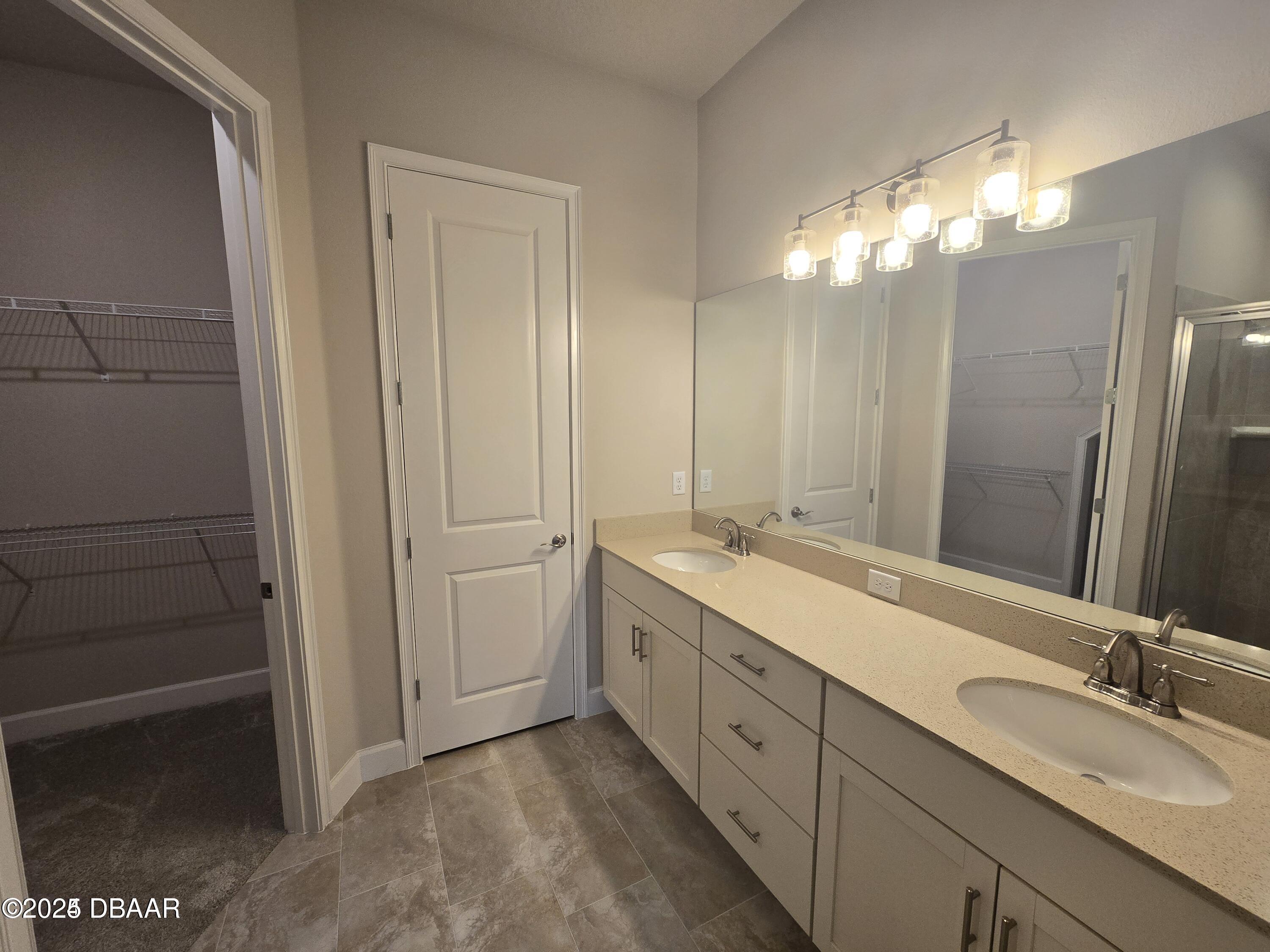 54 Longridge Lane Ormond Beach, FL 32174 - Photo 6 of 16 a bathroom with a double vanity sink and a mirror