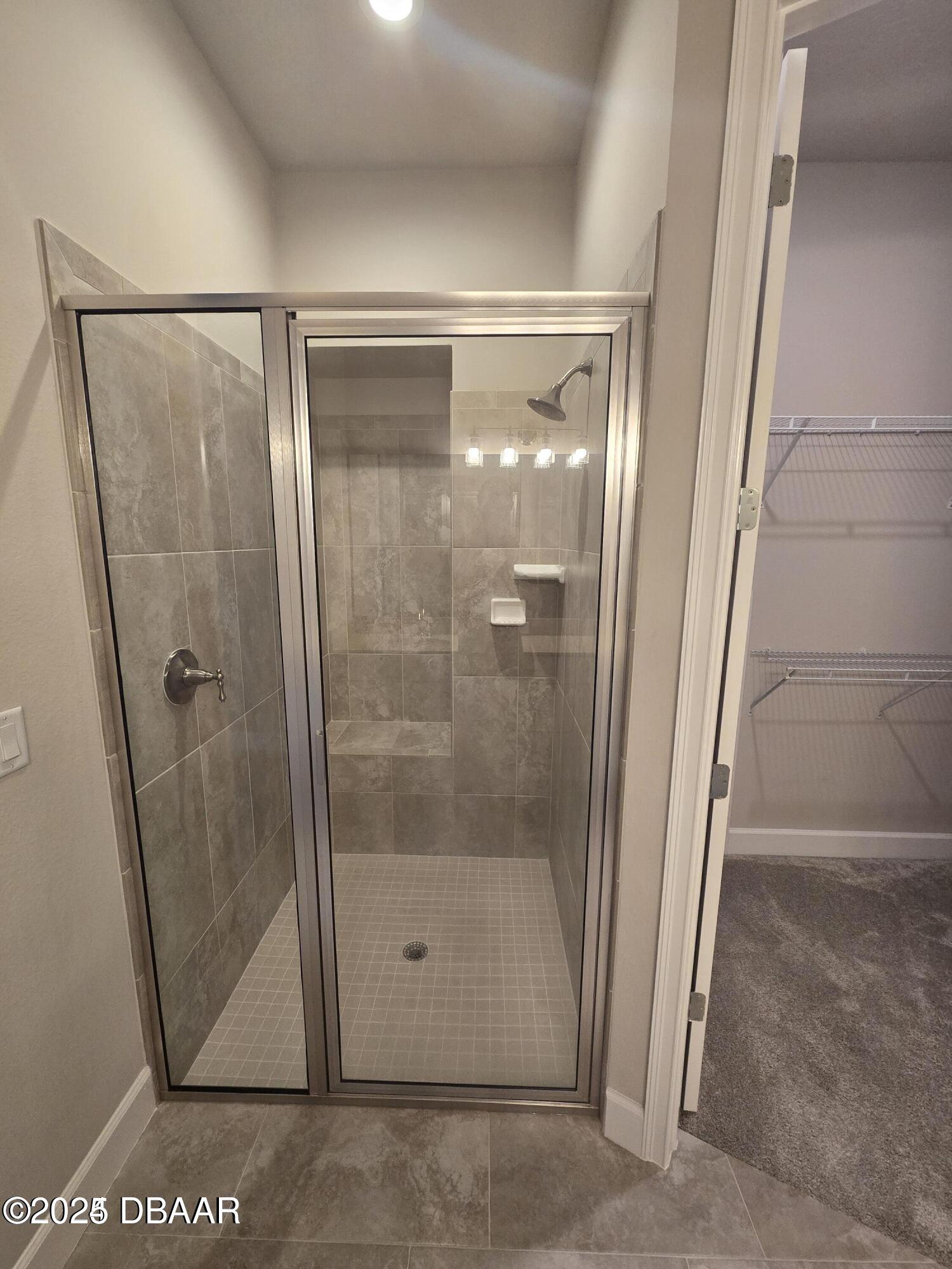 54 Longridge Lane Ormond Beach, FL 32174 - Photo 7 of 16 a bathroom with a glass shower door