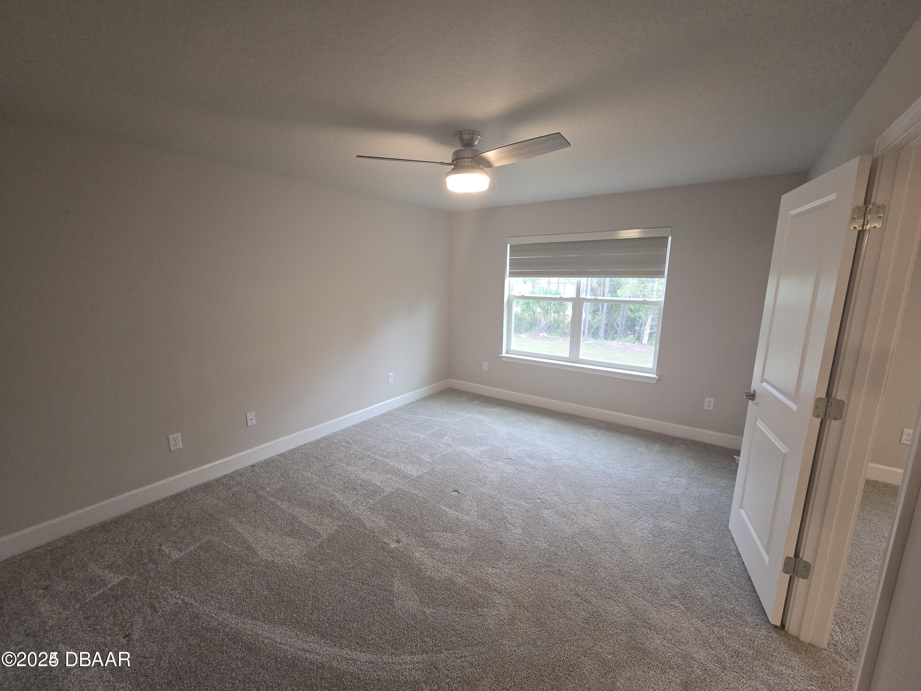 54 Longridge Lane Ormond Beach, FL 32174 - Photo 9 of 16 an empty room with windows and closet