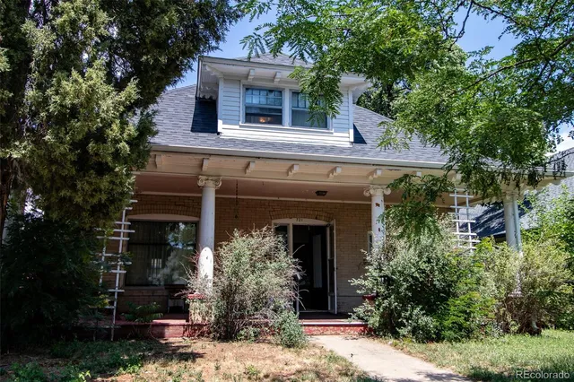 front view of house with a tree