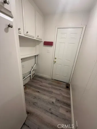 a view of storage and utility room with wooden floor