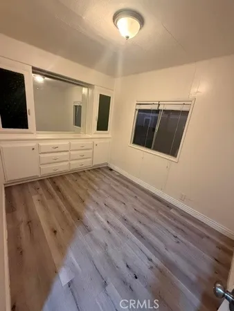 a view of living room with wooden floor